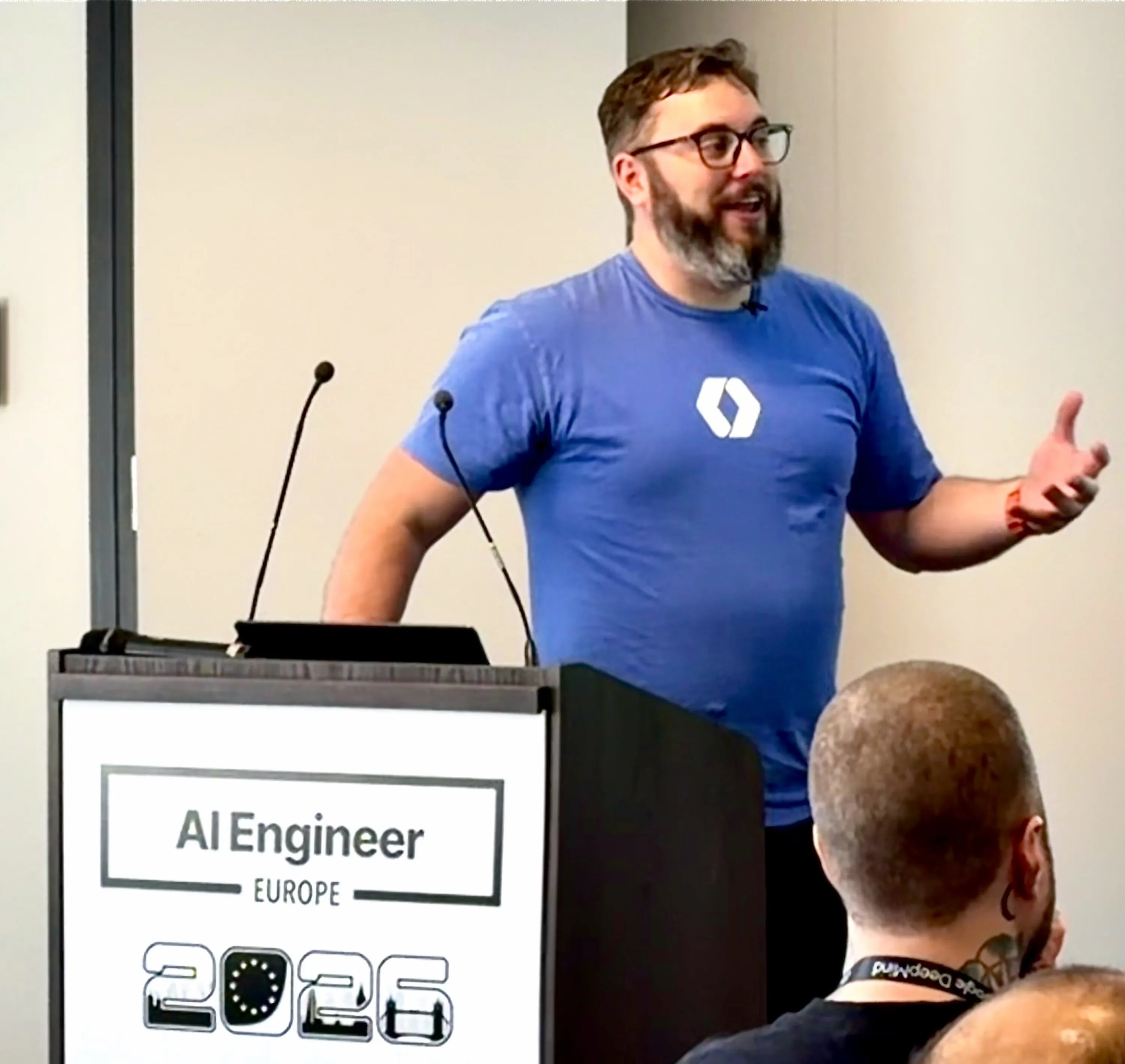 Nick on stage at AI Engineer Europe 2026, presenting Building AI Systems that Ship